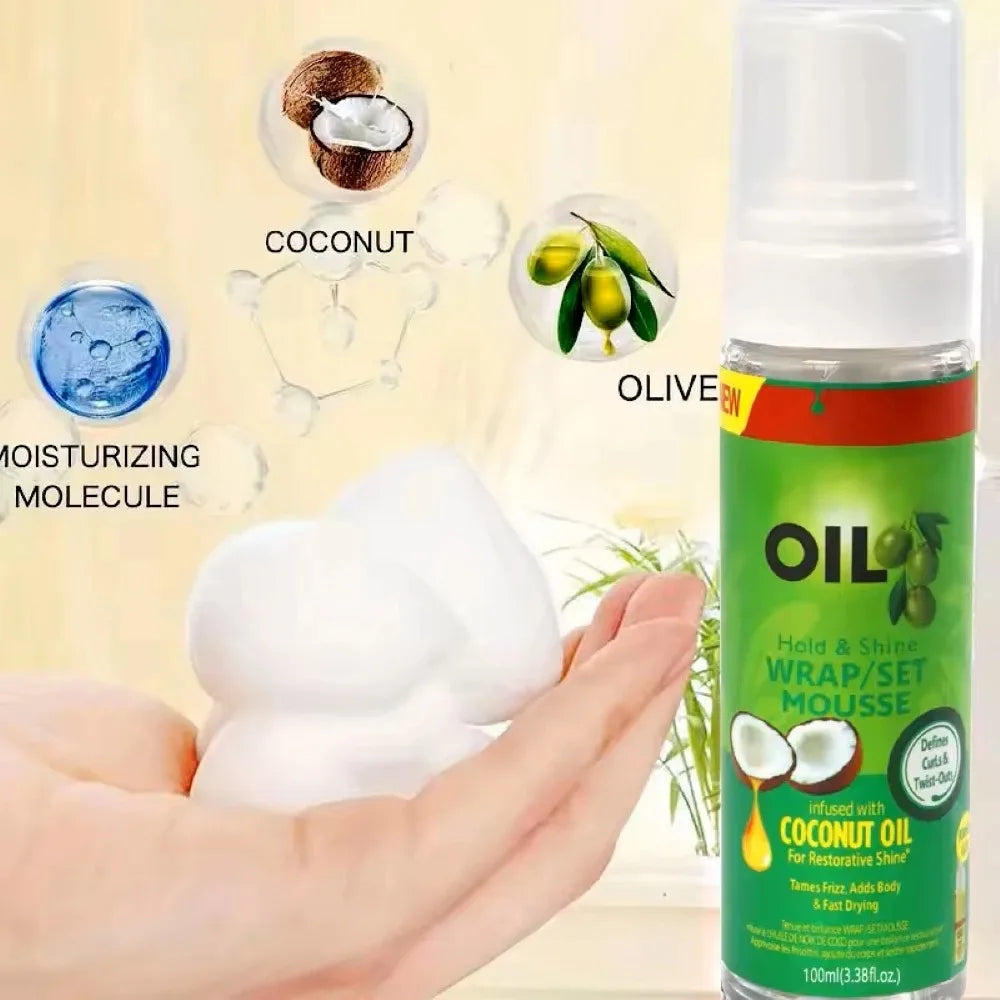 Curly hair mousse for wigs 100ml in hand with moisturizing coconut and olive oil benefits displayed.